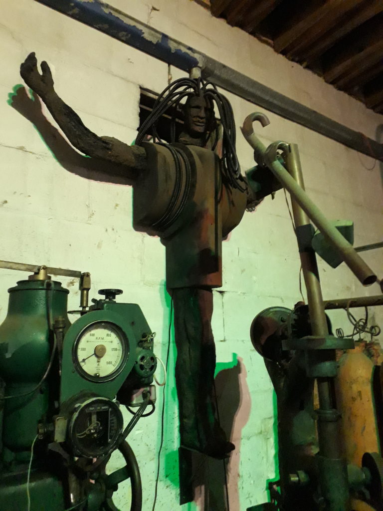 A jesus christ figure hanging on the wall in Steampunk Headquarter Oamaru