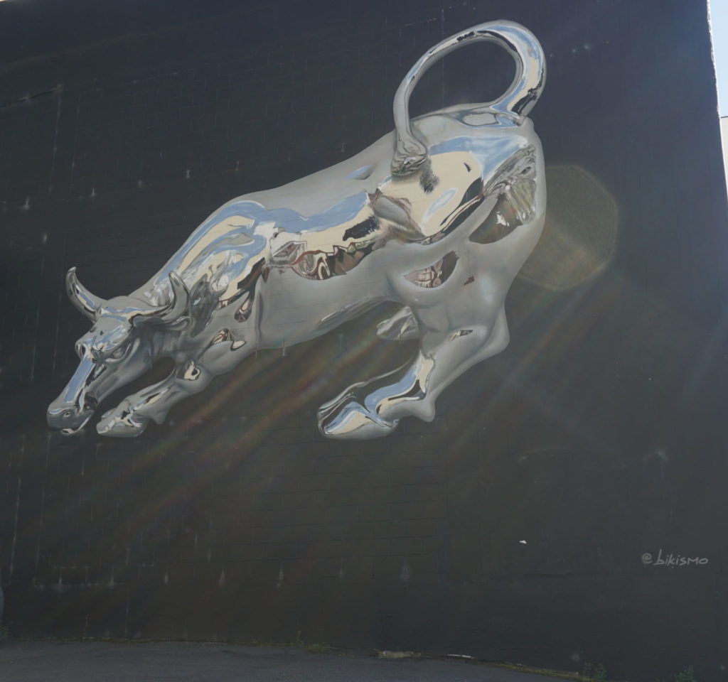 Street Art Dunedin, a drawing on a wall, a silver and shiny looking bull