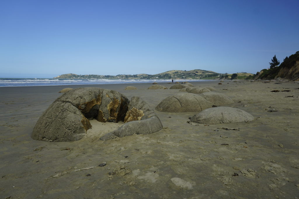 The Moeraki Boulders are unusually large spherical boulders lying along a stretch of a beach on the wave-cut Otago coast of New Zealand between Moeraki and Hampden. These boulders are grey-colored septarian concretions.